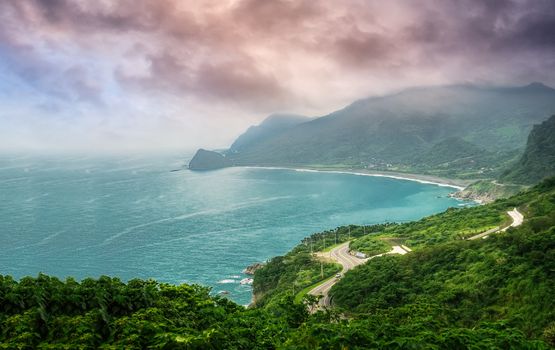 Ocean of bay with forest and roads in the cloudy sky.