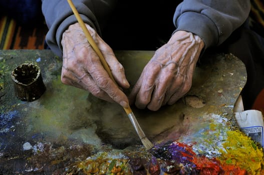 Working hands of honoured artist