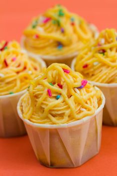 Cupcakes decorated with yellow frosting and sugar