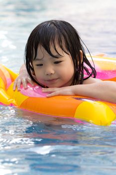 Little girl is having fun in swimming pool
