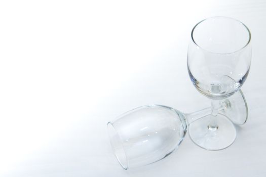 Two empty wine glasses isolated on a white background