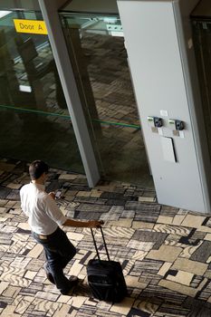 Man texting using smart phone in the boarding room at the airport