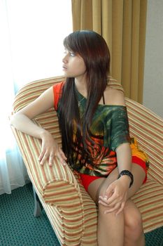 young asian lady sit down in nice sofa