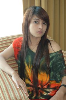 young asian lady sit down in nice sofa