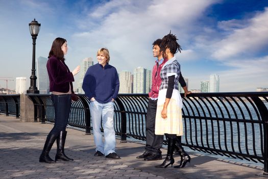 A group of friends on a city walk way by the water