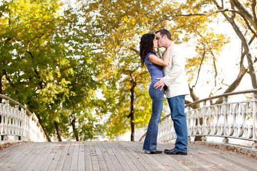 A couple kissing while walking in the park