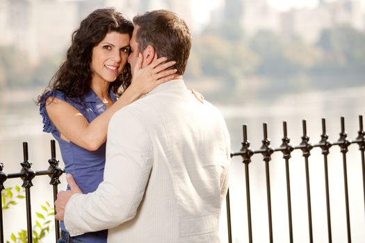 A couple hugging in the park - eye contact with the female