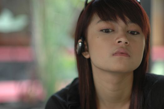 young asian lady wearing phone headset