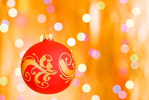 Christmas decorative sphere over gold blurred background
