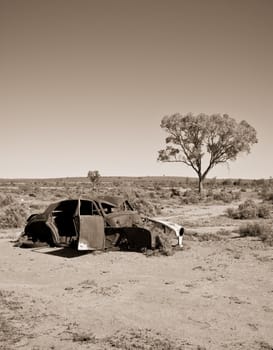 great image of an old car rusting away in the desert