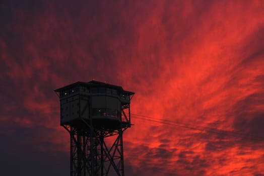 a tower with a background of a stunning pink sunset
