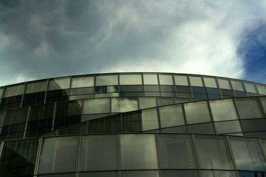 Business building, yellow glass, clouded sky background
