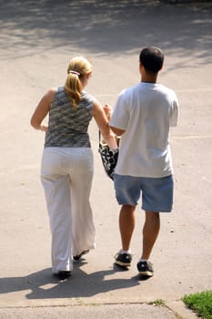 Couple walking away on a sunny day