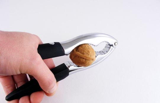 A tool for cracking nuts and lobster tails against an off-white background.