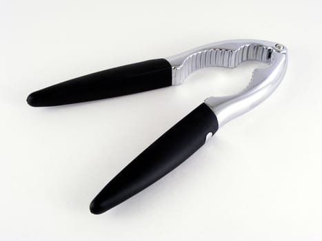 A tool for cracking nuts and lobster tails against an off-white background.