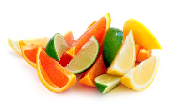 Wedges of assorted citrus fruits isolated on white background