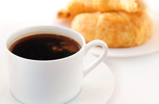 Breaksfast of black coffee and fresh croissants