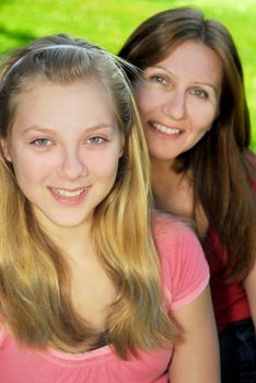 Portrait of smiling family of mother and her teenage daughter