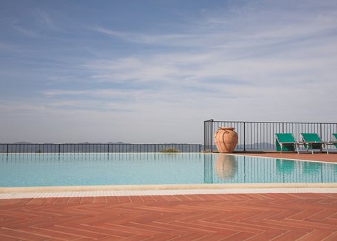 Luxury outdoor swimming pool overlooking distant hills.