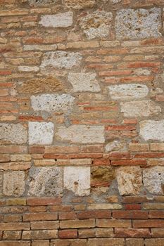 Old historic wall in Tuscany showing different architectural styles.