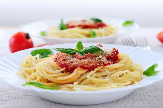 Pasta with tomato sauce basil and grated parmesan