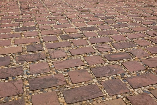 Stones of the pavement pattern of brick background