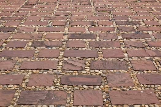 Stones of the pavement pattern of brick background