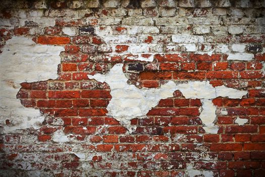 Grunge red brick wall texture with remaining plaster (stucco)