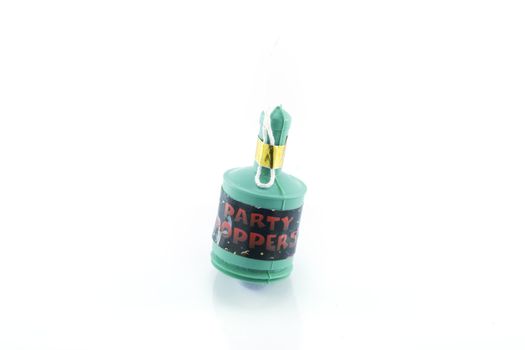 Single party popper on a reflective white background