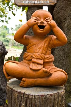 statue of a cute little monk in temple Thailand