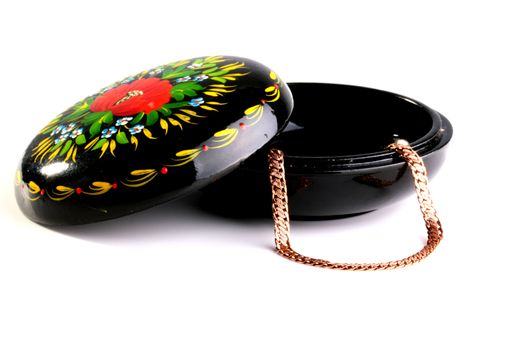 Wooden box covered with a black varnish and ornamented in Russian style. The box is intended for storage of jewelry: chains, earrings, rings.