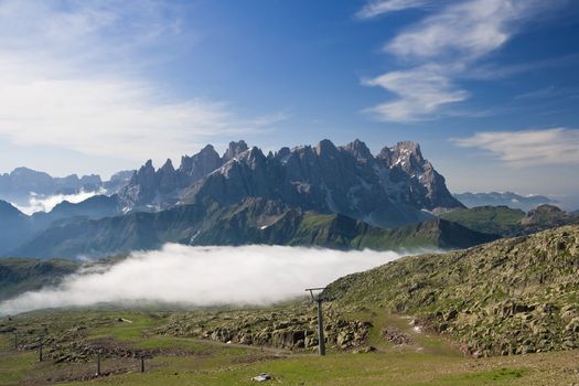 summer view of dolomites  mountain with cableway near San Pellegrino pass, Trentino, Italy. On the background Pale San Martino mountain.