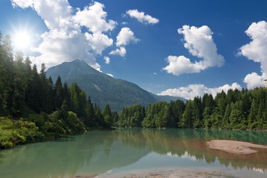 summer view of  Soraga lake in Val di fassa, Trentino, Italy