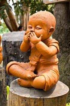 statue of a cute little monk in temple Thailand