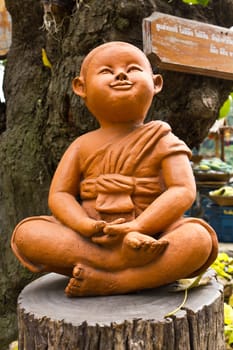 statue of a cute little monk in temple Thailand