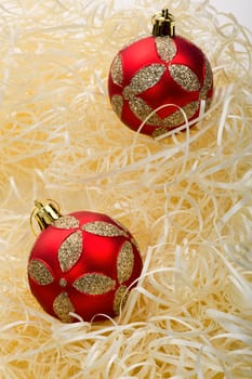 Two red christmas balls with yellow stripes