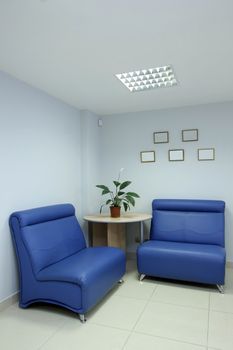 Lobby with armchairs at large office