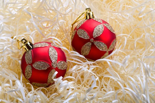 Two red christmas balls with yellow stripes