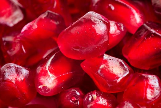 Pomegranate seeds arranged as a background. Extreme close-up.