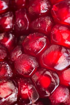Pomegranate seeds arranged as a background. Extreme close-up.