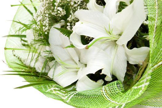 Bouquet of white lilies in green textile over white