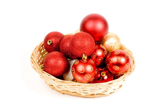 basket filled with red and golden christmas balls isolated on white