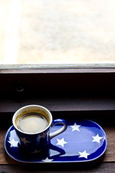 Cup of coffee near the window