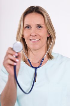 blond woman doctor with stethoscope in hospital