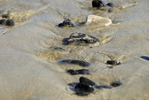 Stones on sea shore focus on single stones