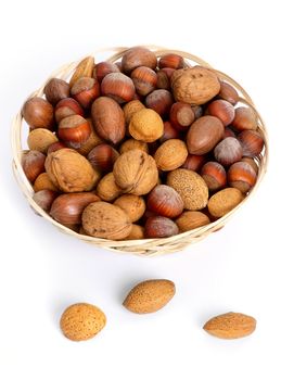 Various nuts in a small straw basket. Close-up