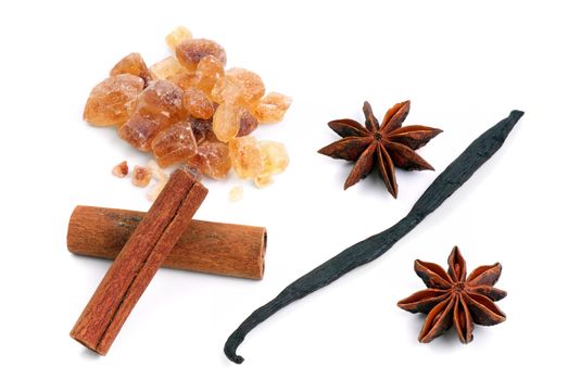 Star anise, cinnamon, vanille and brown sugar on a white background