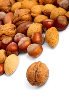 Scattered miscellaneous nuts on white background. Close-up