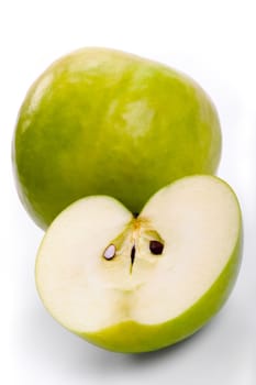 The ripe apples - whole and cut in half. A close up