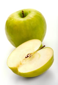 The ripe apples - whole and cut in half. A close up